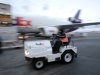 In this Dec. 13, 2011 photo, a cargo handler drives a tug past a FedEx cargo plane at the FedEx hub at Los Angeles International Airport in Los Angeles. FedEx is sticking with its profit expectation for the fiscal year ending in May after reporting fiscal second-quarter earnings that soared from a year ago.(AP Photo/Jae C. Hong)