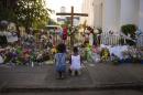 Two children pray near flowers and cards left in condolence outside Emanuel AME Church in Charleston, South Carolina, on June 23, 2015