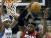 Miami Heat's LeBron James, right, beats Minnesota Timberwolves' Dante Cunningham in the second half of an NBA basketball game for one of his 10 rebounds Monday, March 4, 2013, in Minneapolis. The Heat won 97-81. (AP Photo/Jim Mone)