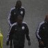 Referee Coulibaly and his assistants Diarra and Bouende-Malonga walk on field in heavy rain before African Nations Cup Group A soccer match between Zambia and Libya at Estadio de Bata