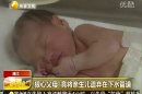 In this still image made from video from May 25, 2013, a baby who was rescued after being trapped in a sewage pipe just below a squat toilet in a public building, lies on a bed at a hospital in Jinhua city, eastern China. A 22-year-old single woman who alerted the authorities of a newborn boy trapped in a sewer in eastern China has admitted that she was the mother, but had refused to come forward because she could not support the child. (AP Photo/Shaanxi TV via AP Video) CHINA OUT