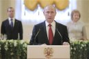 Russia's new President Vladimir Putin (front), speaks during a reception dedicated to the start of his term as Russia's new President at the Kremlin in Moscow