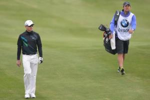 England's Simon Dyson (L) walking on the 18th fairway …