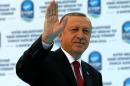Turkish President Tayyip Erdogan greets his supporters during an opening ceremony in Istanbul