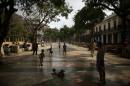 Children play at Paseo del Prado street ahead of unveiling of Chanel's latest Cruise collection in Havana