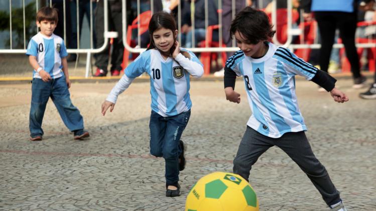 Children wearing Argentina jerseys play soccer at fan gallery in Sao Paulo