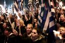 Supporters of Golden Dawn hold Greek flags and torches on January 30, 2016 during a gathering in central Athens to commemorate the death 1996 Imia crisis that brought Greece and Turkey to the brink of war