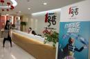 FILE - This Thursday, Nov. 12, 2015, file photo, shows the Yihaodian office in Shanghai. Wal-Mart bought an initial stake in JD.com, China's second-largest e-commerce site, in a deal that gave JD.com ownership of its Chinese e-commerce site Yihaodian. Wal-Mart and JD.com are offering more choices for Chinese shoppers ahead of Singles Day, one of the world's biggest online shopping days of the year. Singles Day, Nov. 11, is China's answer to Cyber Monday in the United States. (AP Photo/Ng Han Guan, File)