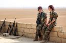Shirin (L) and Kazîwar (R), members of the Kurdish female Women's Protection Units rest some 40 kms away from Raqa on November 9, 2016
