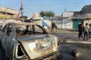 A burnt vehicle at the site of a car bomb in Bayaa, a predominantly Shiite neighbourhood of west Baghdad, which killed six people on December 3, 2013
