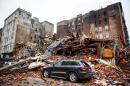 A car sits amongst the rubble after an explosion destroyed four buildings in New York