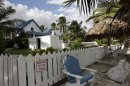 A worker walks into of the home of anti-virus software pioneer John McAfee in San Pedro, Belize
