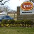 FILE - In this Jan. 29, 2006, file photo, a car passes in front of a Tyson Foods Inc., sign at Tyson headquarters in Springdale, Ark.  The nation's largest meat company on Friday, Oct. 12, 2012, says it's launching an animal treatment audit of suppliers' farms. The news comes as animal welfare activists have been pressuring Tyson to move away from cramped cages for pregnant pigs. (AP Photo/April L. Brown, File)