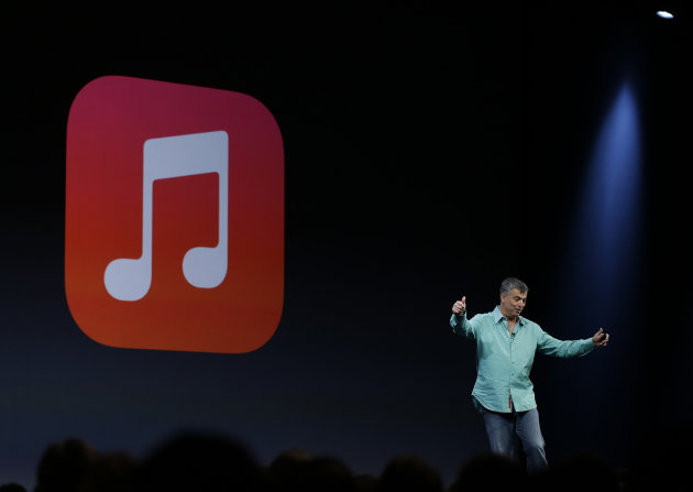 Eddy Cue the Apple senior vice president of Internet Software and Services gestures to applause after demonstrating the new iTunes Radio during the keynote address of the Apple Worldwide Developers Conference Monday, June 10, 2013 in San Francisco. (AP Photo/Eric Risberg)