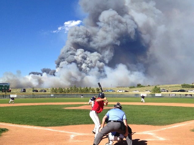 The Black Forest fire is seen in the back of the Pine Creek baseball diamond — Twitter