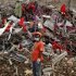 A Bangladeshi rescuer stands amid the rubble of a garment factory building that collapsed on April 24 as they continue searching for bodies in Savar, near Dhaka, Bangladesh, Sunday, May 12, 2013. Search teams resumed their rain-interrupted work Sunday as the death toll from the collapse continued to climb past 1,100. (AP Photo/A.M. Ahad)