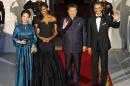 President Barack Obama, right, and Chinese President Xi Jinping, second from right, wave along with, wives Peng Liyuan, left, and first lady Michelle Obama as they arrive for a state dinner at the White House in Washington, Friday, Sept. 25, 2015. (AP Photo/Steve Helber)