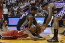 Miami Heat's Allen scrambles for loose ball with Sacramento Kings' Salmons and Cousins during their NBA basketball game in Miami