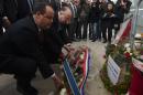 Tunisian Interior Minister Mohammed Najem Gharsalli (L) and French Interior Minister Bernard Cazeneuve (2L) lay a wreath at the Bardo Museum on March 20, 2015 in Tunis, two days after an attack by gunmen