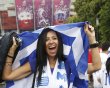 A Greek soccer fan cheers outside a soccer stadium, venue of Euro 2012 soccer championships in Warsaw