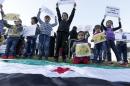 Syrian children carry placards as they call for the lifting of the siege off Madaya and Zabadani towns in Syria, in front of the offices of the U.N. headquarters in Beirut, Lebanon