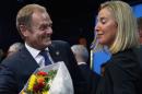 Newly elected European Council President Donald Tusk and newly elected European High Representative for Foreign Affairs Minister Federica Mogherini talk together during a EU summit in Brussels