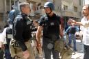 This photo taken on August 28, 2013 in the Eastern Ghouta area on the northeastern outskirts of Damascus shows UN arms experts arriving to inspect a site suspected of being hit by a deadly chemical weapons attack