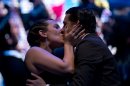 Argentina's dancers Facundo de la Cruz Gomez Palavecino, right, and Paola Sanz kiss as they celebrate after winning the 2012 Tango Dance World Cup salon finals in Buenos Aires, Argentina, Monday, Aug. 27, 2012. Couples from around the world competed in the finals Argentina's annual tango competition, the highlight of a two-week festival which this year honored Astor Piazzolla, the legendary composer and bandoneonista who revived the genre and infuriated purists by blending tango with rock music in the 1970s. (AP Photo/Natacha Pisarenko)