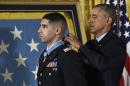 President Barack Obama bestows the nation's highest military honor, the Medal of Honor to Florent Groberg during a ceremony in the East Room of the White House in Washington, Thursday, Nov. 12, 2015. The former Army captain received the medal after he tackled a suicide bomber while serving in Afghanistan. (AP Photo/Susan Walsh)