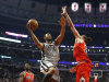San Antonio Spurs center Boris Diaw (33) shoots over Chicago Bulls center Joakim Noah (13) as forward Luol Deng watches during the first half of an NBA basketball game, Monday, Feb. 11, 2013, in Chicago. (AP Photo/Charles Rex Arbogast)