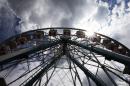 Patrons ride a Ferris Wheel at the Indiana State Fair Thursday, Aug. 14, 2014, in Indianapolis. The fair comes to a close on Sunday, Aug. 17. (AP Photo/Darron Cummings)