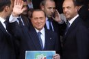 Silvio Berlusconi waves to supporters next to PDL Secretary Angelino Alfano in downtown Rome