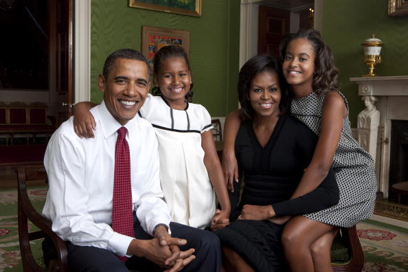 In this handout form the White House, (L to R) U.S. President Barack Obama, daughter Malia Obama, first lady Michelle Obama and daughter Sasha Obama sit for portrait in the Green Room of the White House September 1, 2009 in Washington, DC. (Photo by Annie Leibovitz/White House via Getty Images)