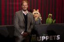 Director Bobin poses with Muppets Miss Piggy and Kermit the Frog during photocall promoting movie The Muppets in Berlin