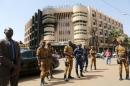 Soldiers stand guard in front of the Splendid Hotel after an attack on the hotel and a restaurant in Ouagadougou