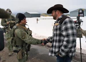 Ammon Bundy, right, shakes hand with a federal agent …
