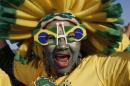 A Brazilian national soccer team fan cheers as she waits for the live broadcast of the World Cup quarterfinals' match between Brazil and Colombia, inside the FIFA Fan Fest area on Copacabana beach, in Rio de Janeiro, Brazil, Friday, July 4, 2014. (AP Photo/Silvia Izquierdo)