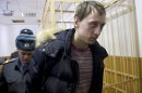 Pavel Dmitrichenko, foreground, is escorted out of a courtroom in Moscow, Russia, on Thursday, March 7, 2013. The star dancer accused of masterminding the attack on the Bolshoi ballet chief acknowledged Thursday that he gave the go-ahead for the attack, but told a Moscow court that he did not order anyone to throw acid on the artistic director's face. The judge, however, refused to release Bolshoi soloist Pavel Dmitrichenko on bail and ordered him held until at least Apr. 18 while the investigation continued. (AP Photo/Ivan Sekretarev)