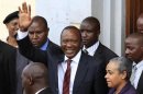 President elect Uhuru Kenyatta greets his supporters in the company of his wife Margaret soon after attending a church service in his rural home town of Gatundu