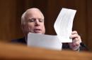 Sen. McCain reads the restrictions for visitors to immigration centers