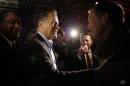Mitt Romney, the former Republican presidential nominee, left, greets people after speaking during the Republican National Committee's winter meeting aboard the USS Midway Museum Friday, Jan. 16, 2015, in San Diego. (AP Photo/Gregory Bull)