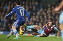 Chelsea's Mikel, at rear, slides in a tackle with West Ham's Mark Noble during the English Premier League soccer match between Chelsea and West Ham United at Stamford Bridge stadium in London, Wednesday, Jan. 29, 2014.(AP Photo/Alastair Grant)