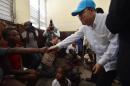 UN Secretary-General Ban Ki-moon greets victims of the Hurricane Matthew at a shelter in the Lycee Phillipe Guerrier in the city of Les Cayes, in the southwest of Haiti, on October 15, 2016