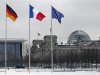 German French and EU flags flutter over the German lower house of parliament in Berlin