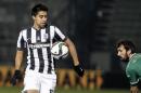 PAOK's Christian Noboa from Ecuador, left, controls the ball against Panathinaikos' Giorgos Koutroumpis during their Super League soccer match at the empty Apostolos Nikolaides stadium in Athens, on Sunday, March 8, 2015. All the weekend soccer matches of the Greek Super League are to be played in front of empty stands, as talks between the Sports ministry of the new left-wing government and the country's soccer authorities aiming to combat the sports-related violence are still under way. (AP Photo/Yorgos Karahalis)