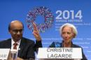 International Monetary Fund (IMF) Managing Director Christine Lagarde, accompanied by IMFC Chair and Singapore's Finance Minister Tharman Shanmugaratnam, speaks during a news conference at the World Bank Group-International Monetary Fund Annual Meetings at IMF headquarters in Washington, Saturday, Oct. 11, 2014. (AP Photo/Jose Luis Magana)