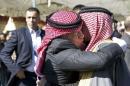 Jordan's King Abdullah offers his condolences to Safi al-Kasaesbeh, the father of Jordanian pilot Muath al-Kasaesbeh, at the headquarters of the family's clan in the city of Karak
