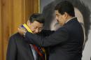 Nicolas Maduro (right) gives Xi Jinping a Venezuelan honour sash during an official visit to Miraflores Presidential Palace, Caracas on July 20, 2014