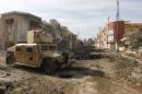 A military vehicle of Iraqi Counter-Terrorism Service (CTS) forces is seen at the site of car bomb attack during a battle with Islamic State militants in Andalus neighborhood of Mosul