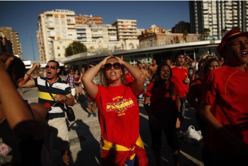 Spain supporters react after Spain's Torres missed a scoring opportunity against Italy as they watch the Group C Euro 2012 soccer match on a giant screen in Malaga